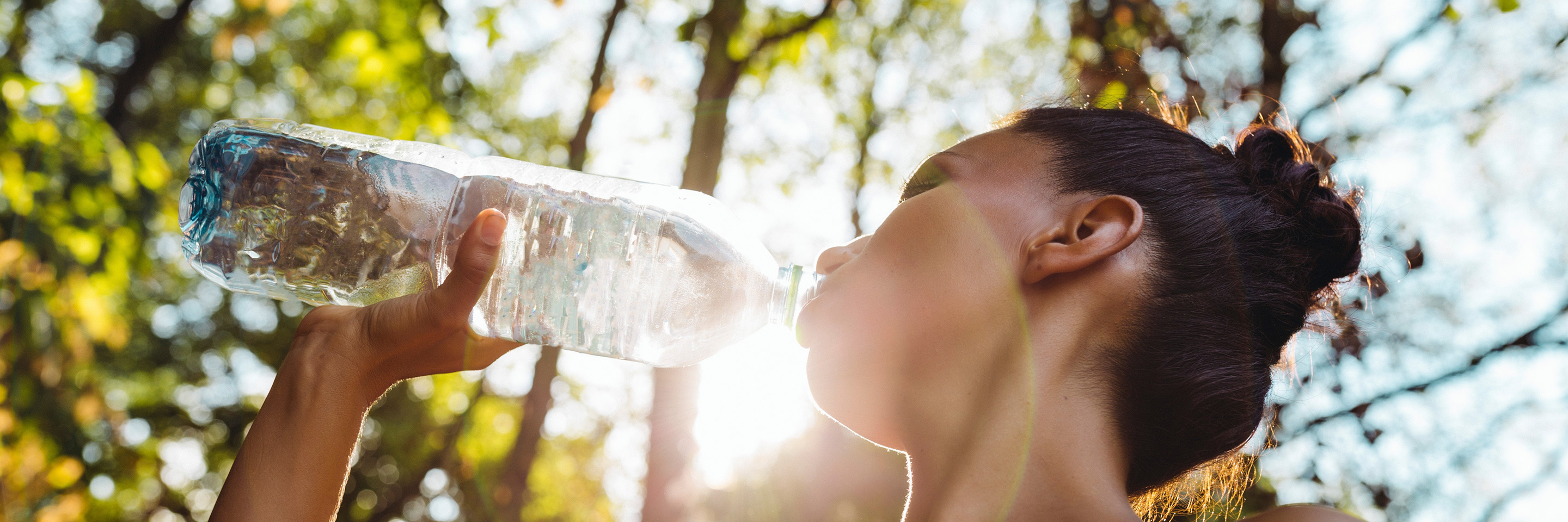 Woman drinking water, Sidel plastic bottle